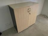 a cabinet in the corner of a room with a window