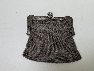 an old silver metal purse with a chain around it