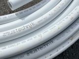 a bunch of white hoses laying on the ground