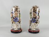 pair of decorative glass vases with flowers in them on a table