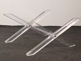 two clear acrylic stools sitting on a black carpet