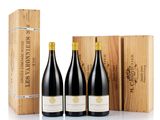 three bottles of wine in a wooden box next to a wooden box