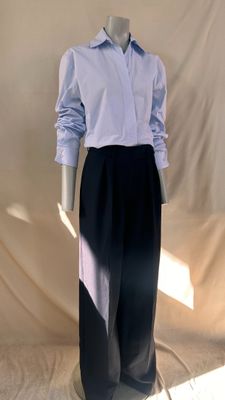 a mannequin dressed in a blue shirt and black pants