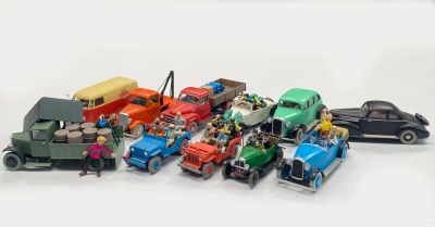 a lot of toy cars that are on a white surface