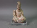 statue of a woman sitting in a lotus position on a clear base