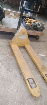 a pallet that is sitting on the ground next to a fork