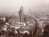 a black and white photo of a city with a clock tower