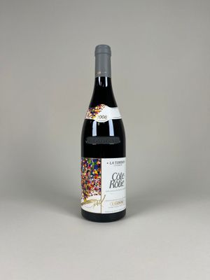 a bottle of red wine with sprinkles on it