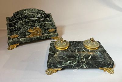 two pieces of green marble with gold decorations on them