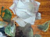 a painting of a white rose on a wooden table