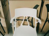 une chaise blanche posée devant une pile de cartons