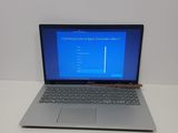a laptop computer sitting on a table with a blue screen