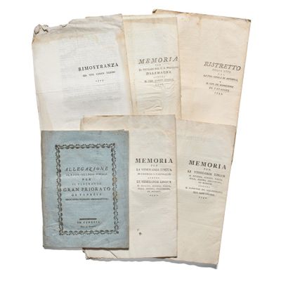 several old books sitting on top of each other on top of a table