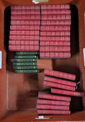 many books in a brown box on a table