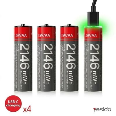 three aa batteries with a green light on top of them