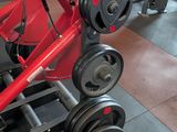 an image of a gym room with a red and black gym equipment