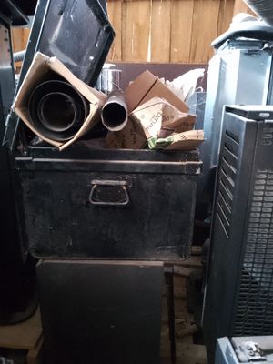 a pile of junk in a room with a tv on top of it