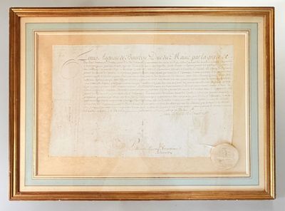 an old document is hanging on a wall next to a vase