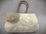 a white purse with a flower on top of it