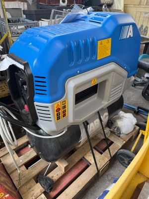 a blue and white machine that is on a pallet