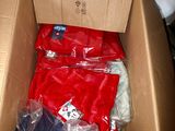 a cardboard box filled with clothes and a remote control