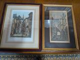 deux photos encadrées représentant des bâtiments, posées sur une table