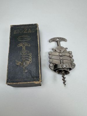 a book and a bottle opener sitting on a table