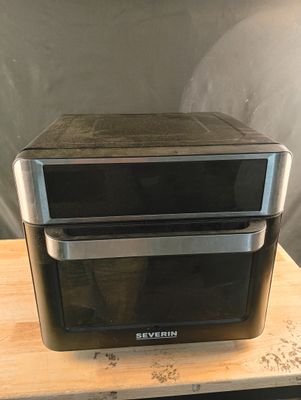 two toasters sitting on top of a wooden table