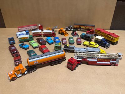 a lot of toy cars and trucks that are on the table