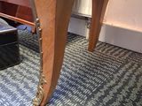 a wooden table with two legs and a drawer underneath it