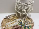 a display of pearls and other jewelry on a table