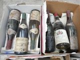 many bottles of wine in a box on the floor