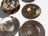 a lot of silver plates that are on the table
