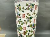 a vase that is sitting on a table next to a small bird