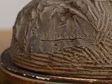 a close up of a statue of a bird on a pedestal