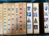 several books are stacked on top of each other on a shelf
