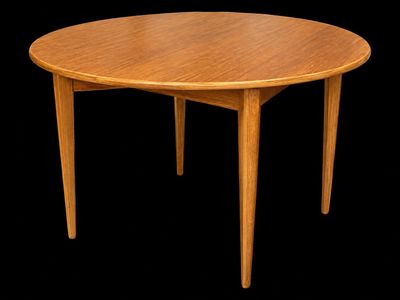 an image of a round wooden table with a black background