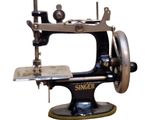 a black and silver sewing machine on a white background