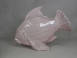 a pink fish shaped object on a white surface