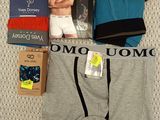 men ' s underwear and underwear are laid out on a bed
