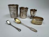silverware including spoons, cups, and spoons on a white surface