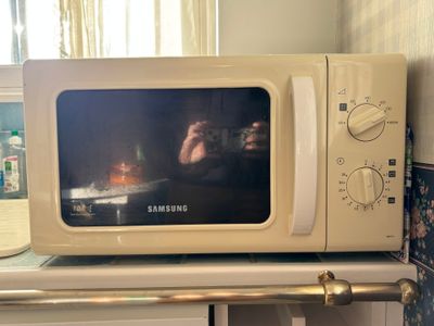a white microwave oven sitting on top of a counter