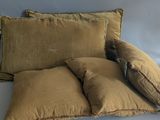 two pillows on a couch with a pillow on top of them
