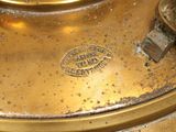 a close up of a brass plate with a clock on it
