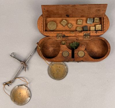 a small wooden box with coins in it and a pair of scissors