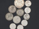 several coins are arranged in a circle on a black surface