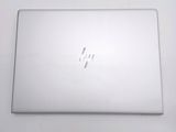 an open laptop computer sitting on top of a white table