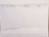 a close up of a piece of paper on a wooden table