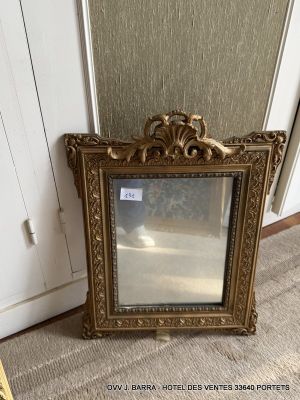 a picture of a mirror sitting on the floor next to a chair