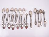 a lot of silver spoons and forks on a table